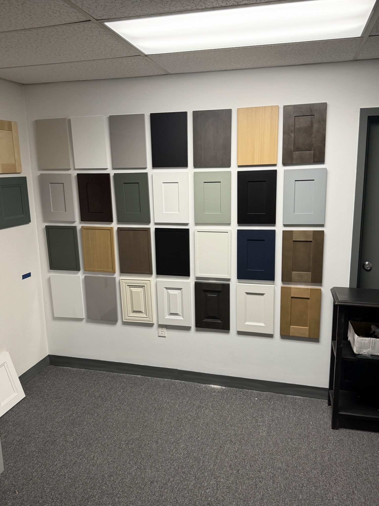 Wall of Perini Cabinets door finish samples