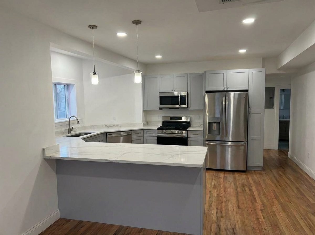 Grey shaker kitchen with stainless appliances and hardwood floor
