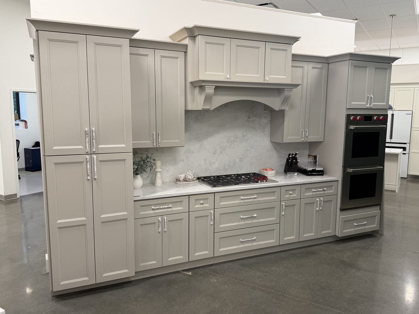 Greige kitchen cabinets with double wall oven