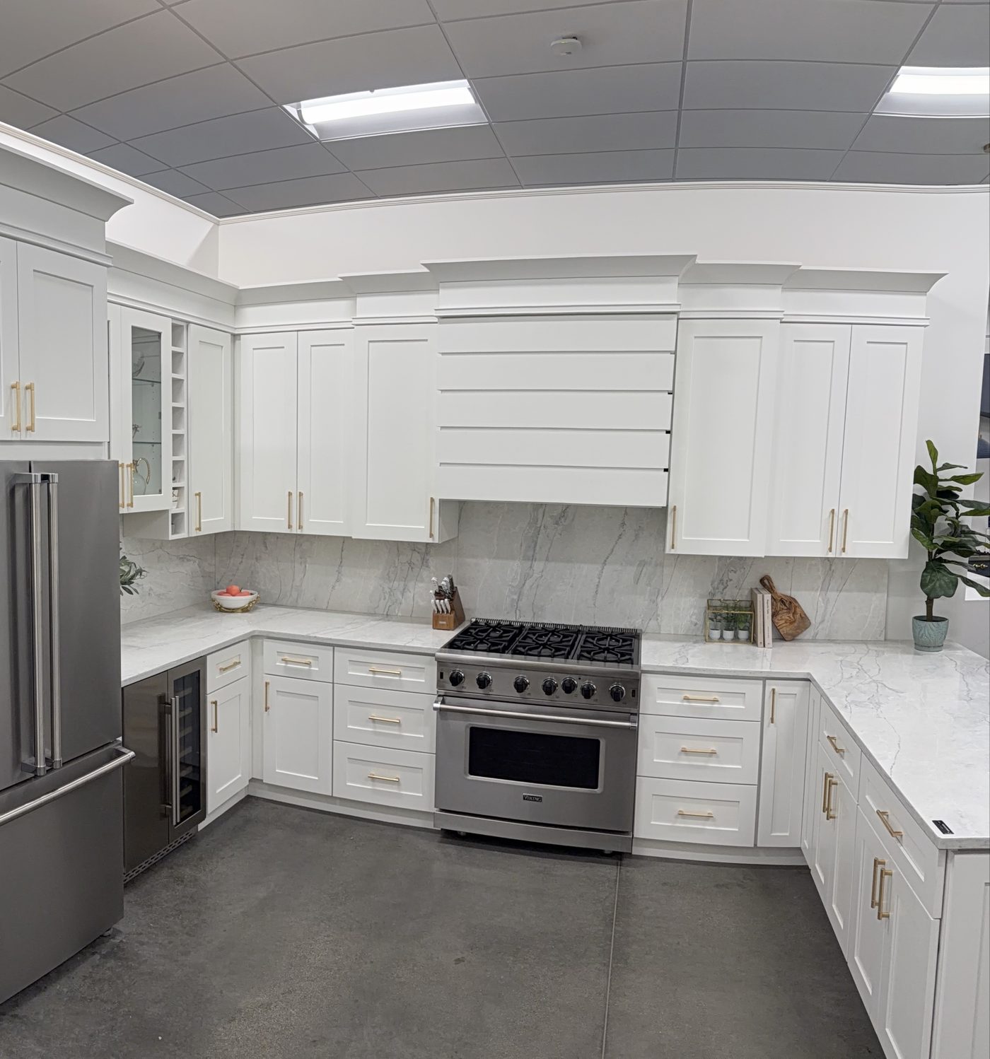White shaker kitchen with gold hardware and Viking range