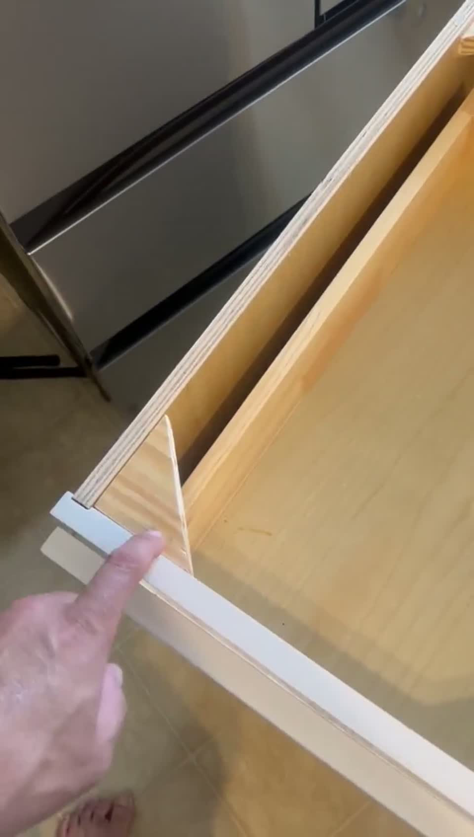 Close-up of soft-close cabinet drawer hardware and glides